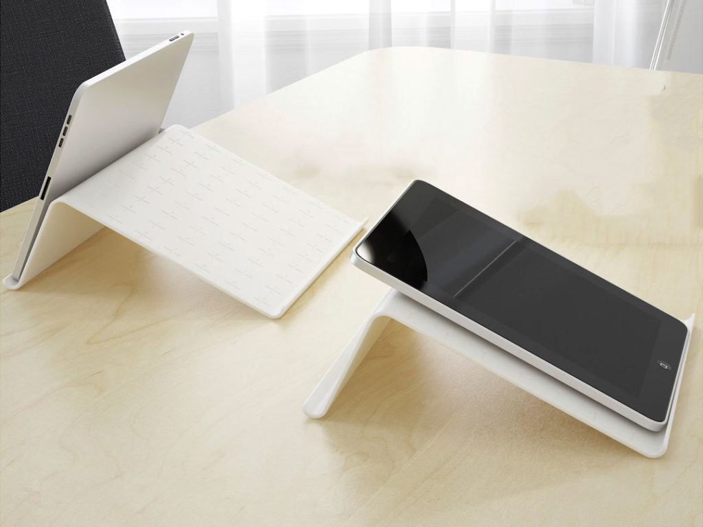 Two tablets on Tablet Stands placed on a light wooden table in a bright, minimalist room