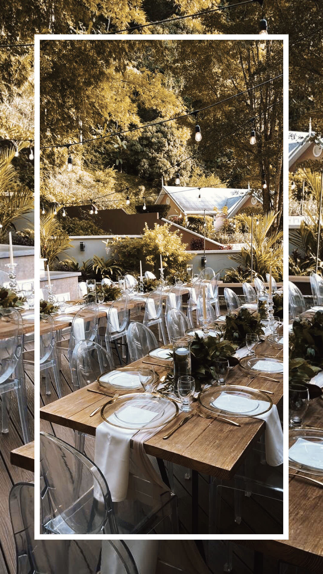 Outdoor wedding reception with long wooden tables and clear chairs