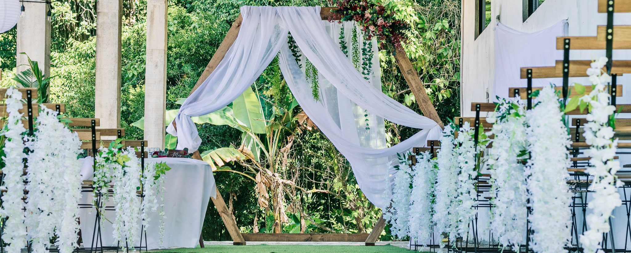 Rustic ceremony with Perched chairs and arch