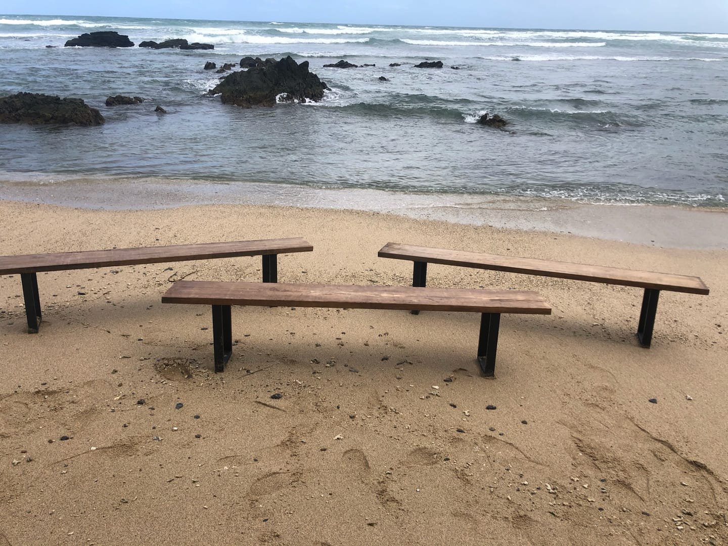 French Farm Bench: A handcrafted bench with a seat of salvaged timber and black metal legs, with the wood grain visible from every side.