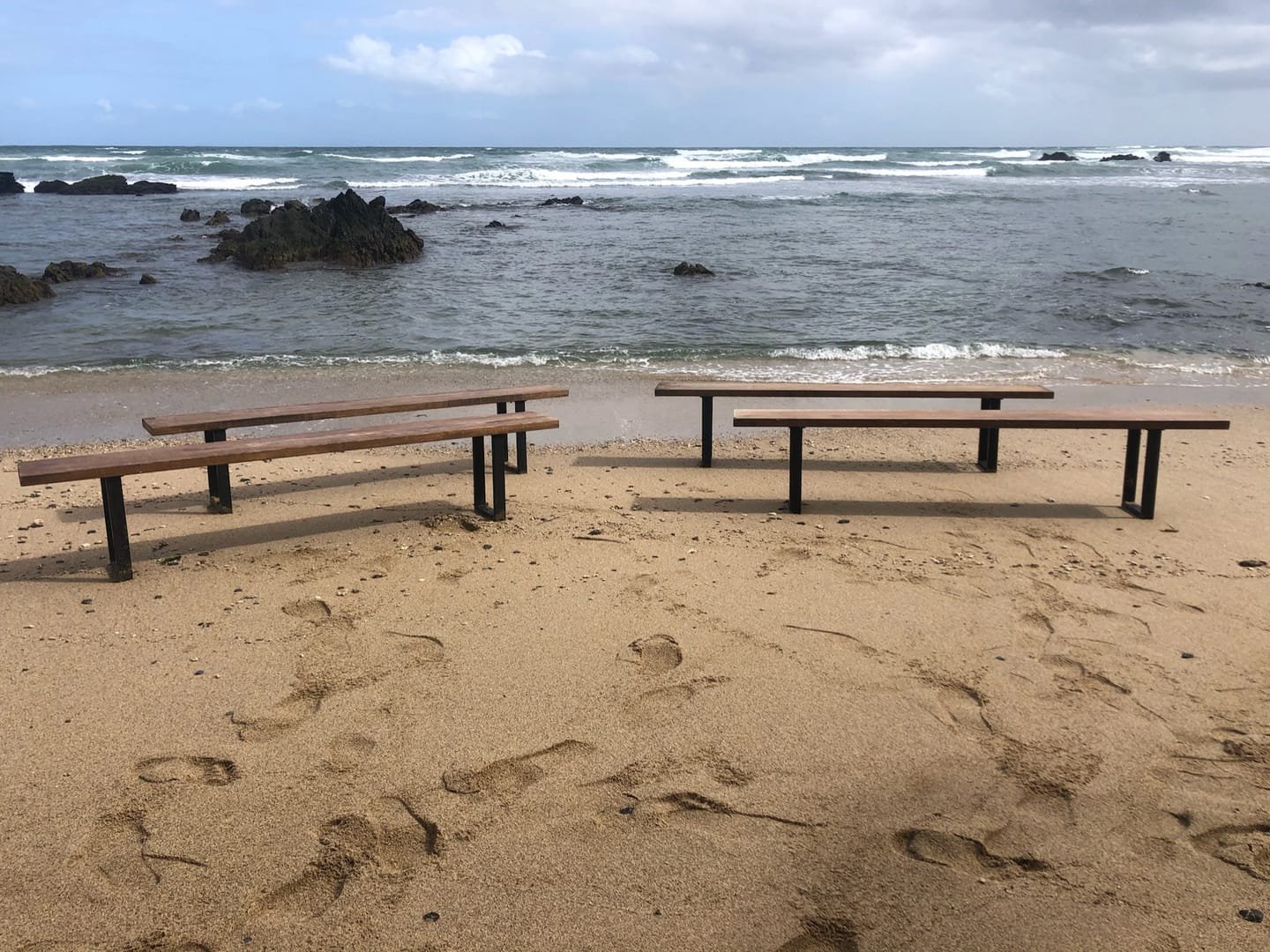 French Farm Bench: A handcrafted bench with a seat of salvaged timber and black metal legs, with the wood grain visible from every side.
