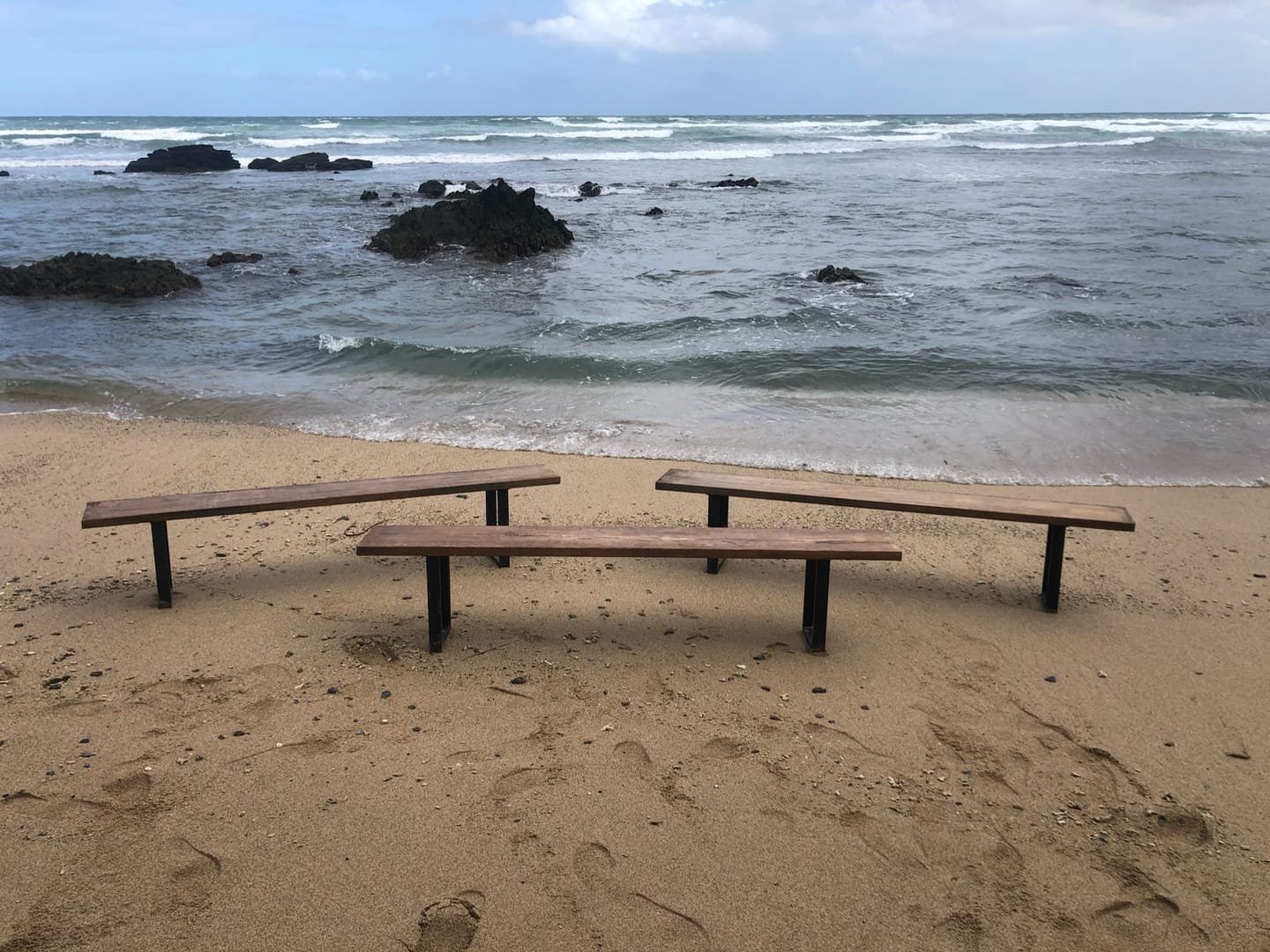 French Farm Bench: A handcrafted bench with a seat of salvaged timber and black metal legs, with the wood grain visible from every side.