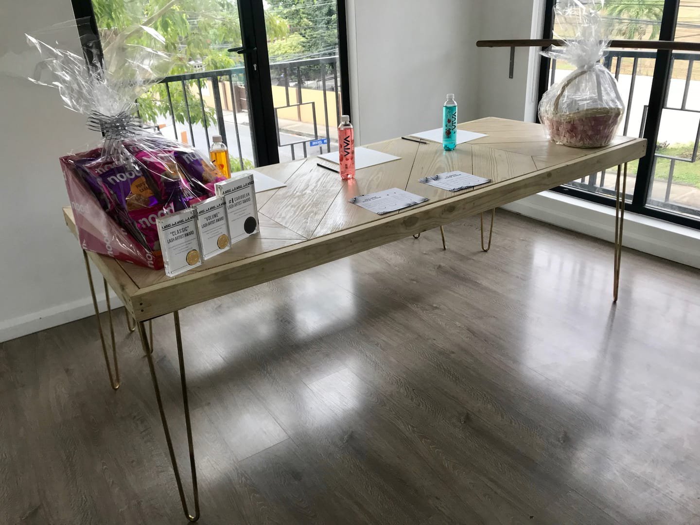 Hairpin Sweetheart Table: A sweetheart table with metal hairpin legs made from raw angle iron and a handcrafted salvaged-timber top, its grain visible from any