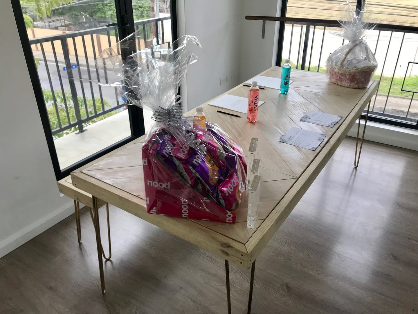 Hairpin Sweetheart Table: A sweetheart table with metal hairpin legs made from raw angle iron and a handcrafted salvaged-timber top, its grain visible from any