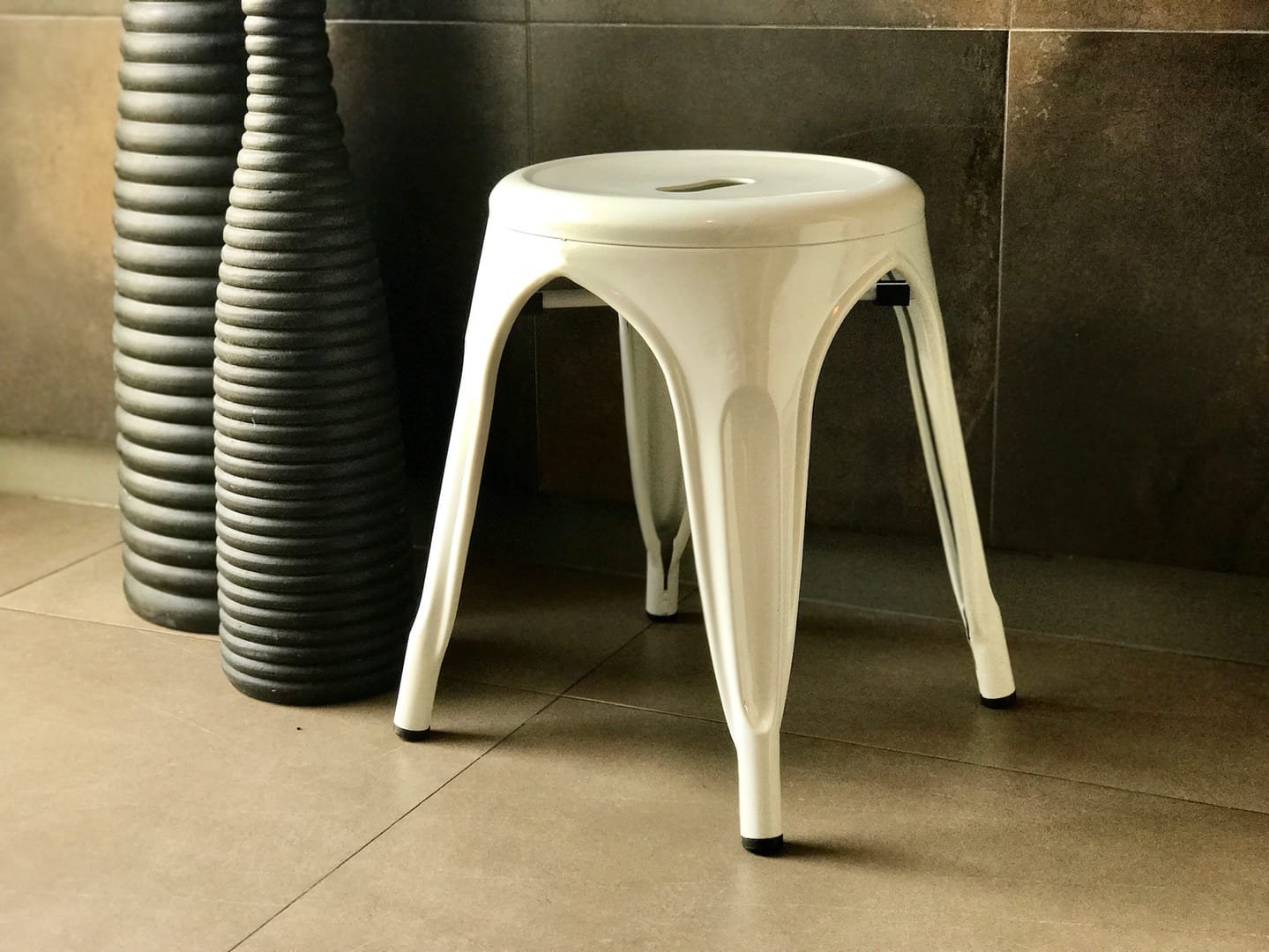Industrial Stool: The Industrial Stool is a short metal stool from the Tolix line, available in black and white.