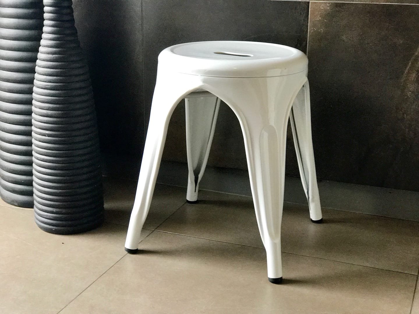 Industrial Stool: The Industrial Stool is a short metal stool from the Tolix line, available in black and white.