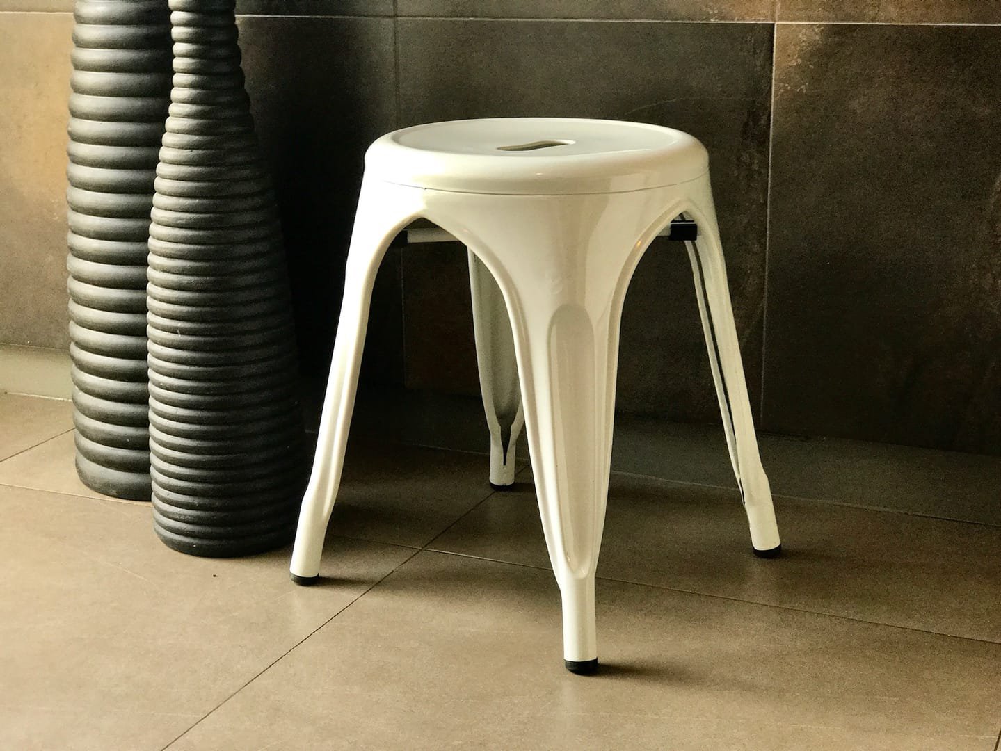Industrial Stool: The Industrial Stool is a short metal stool from the Tolix line, available in black and white.